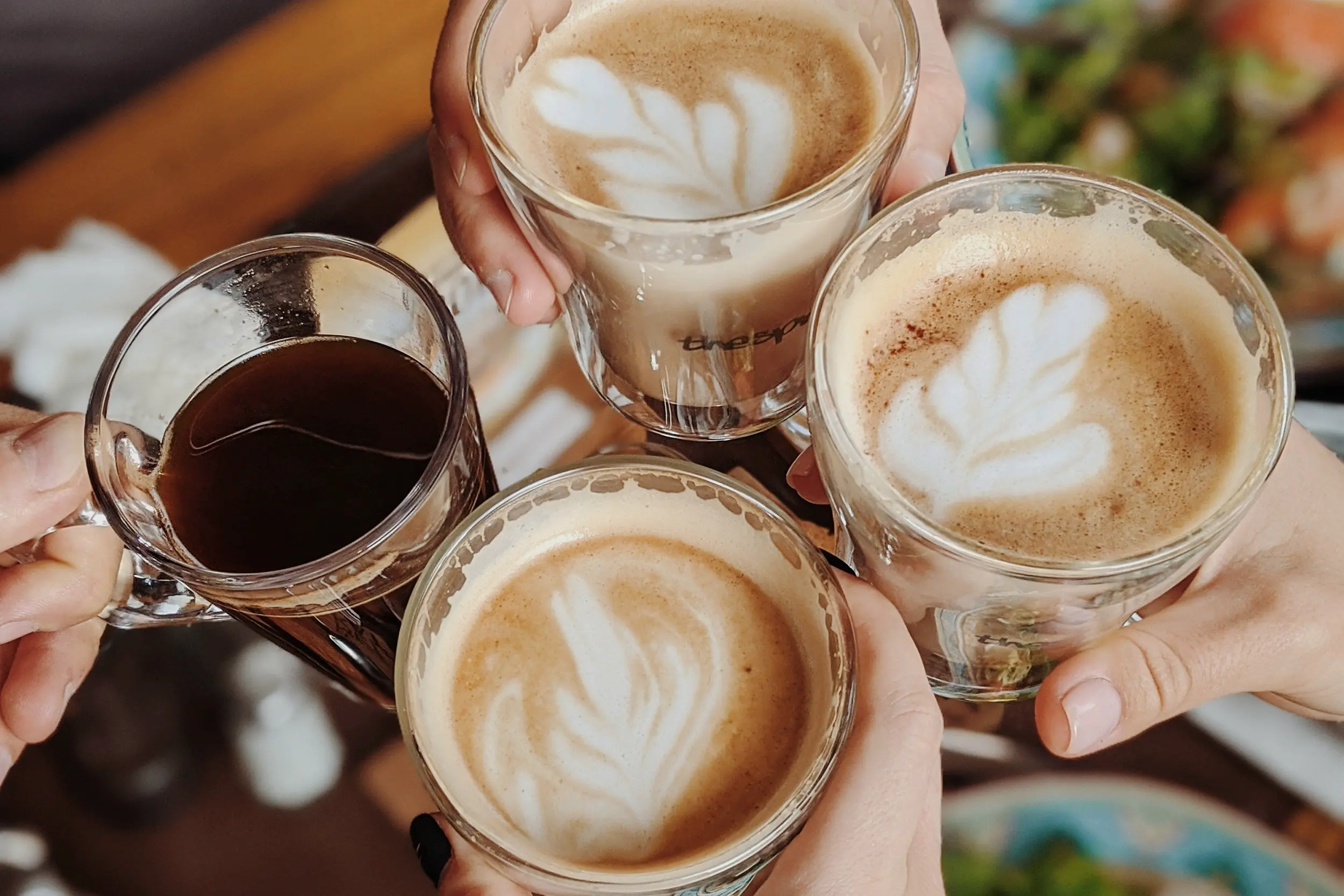 Hands holding cups of coffee