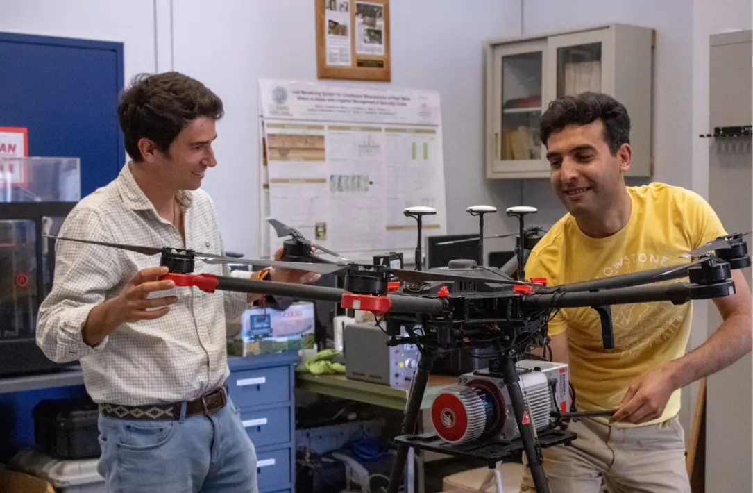 Two people working on a drone