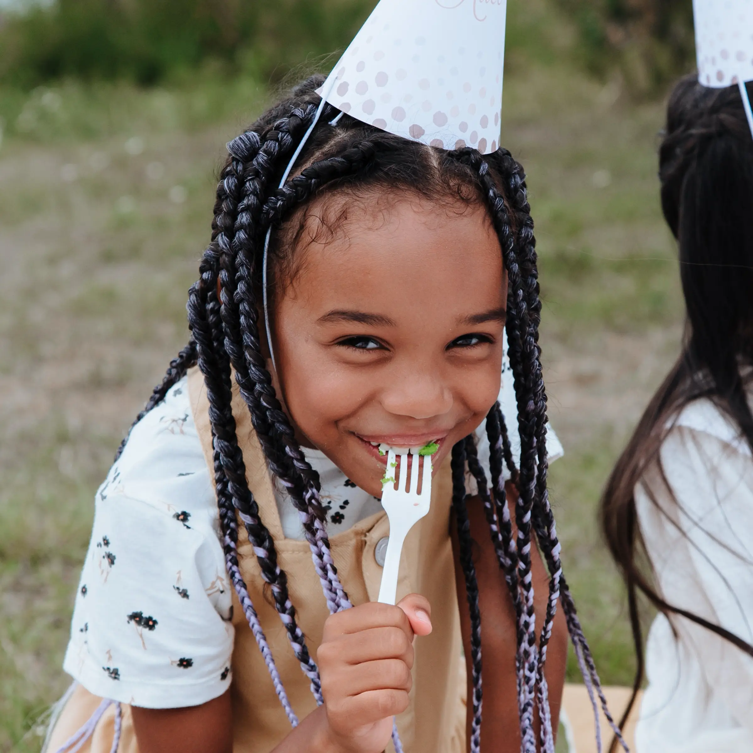 Girl smiling and eating with a fork