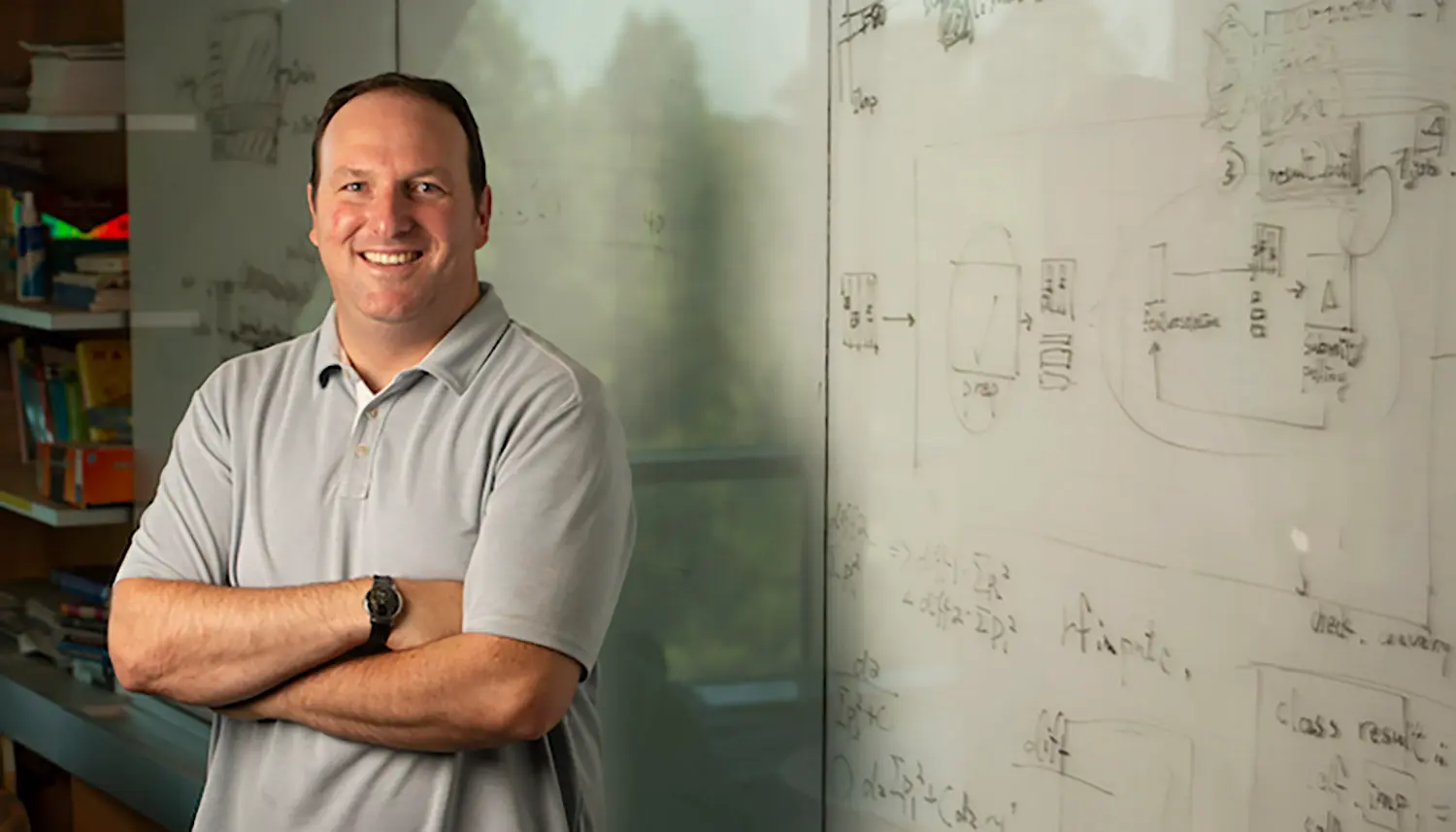 Man standing by a white board with complete formulas