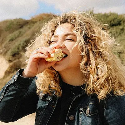 Woman taking a bite of a taco