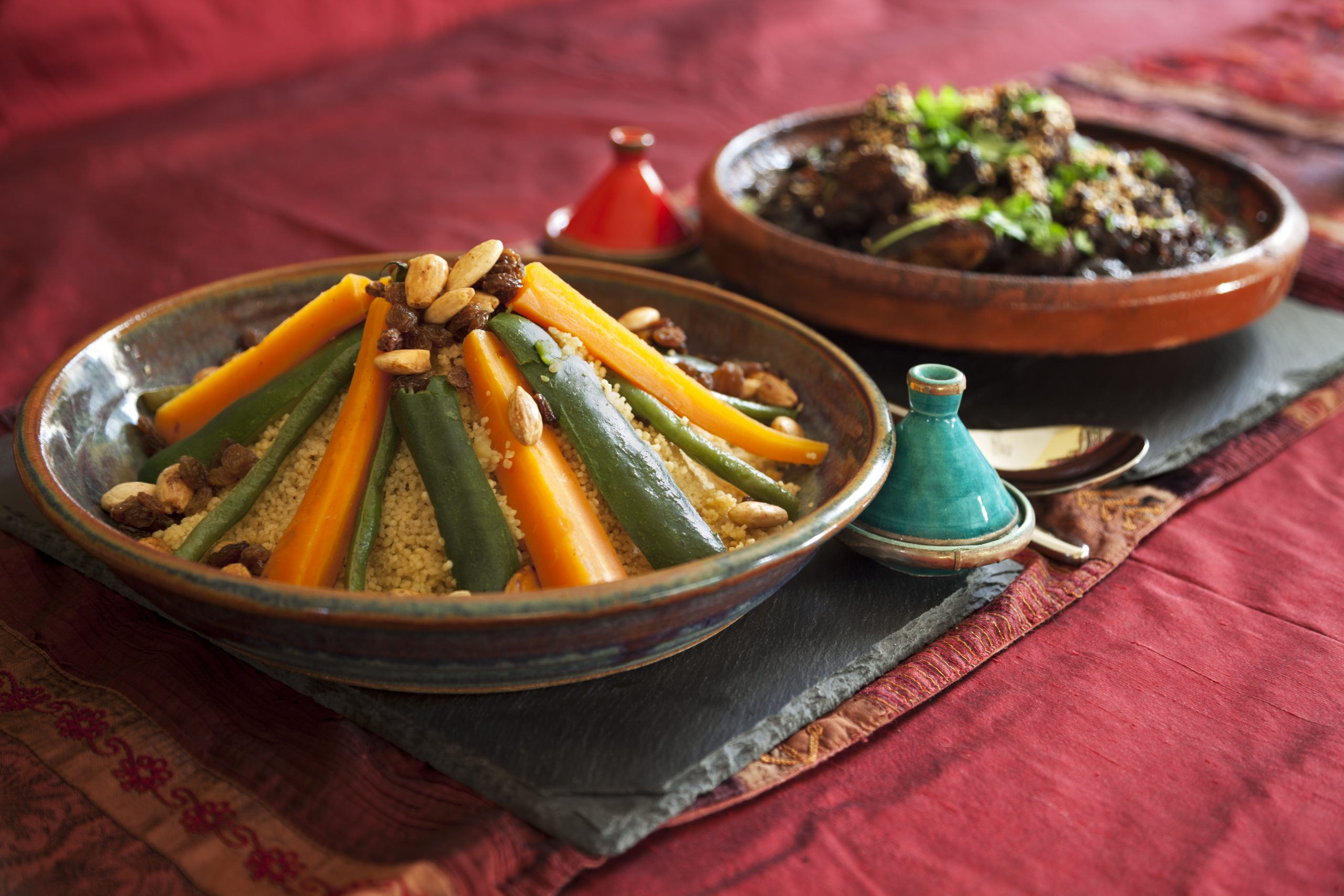 A traditional African meal of vegetable couscous and meat and prune tagine garnished with fresh coriander and sesame seeds. (Getty Images)