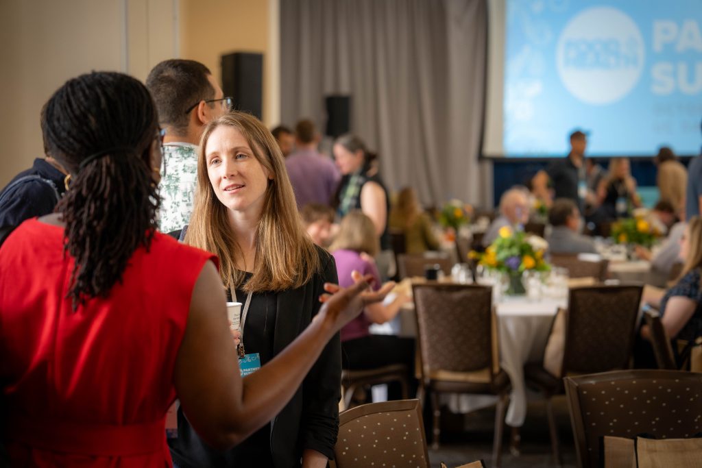 Two individuals speaking at an event