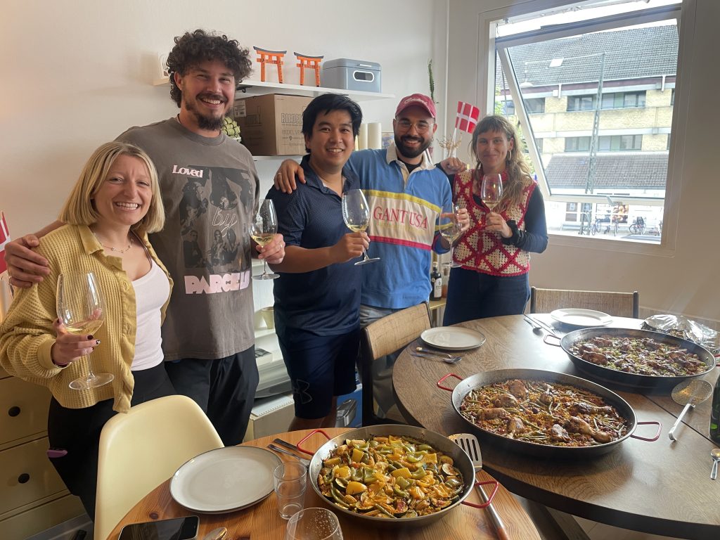 five fellows eating paella