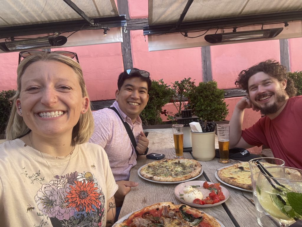 three fellows eating pizza